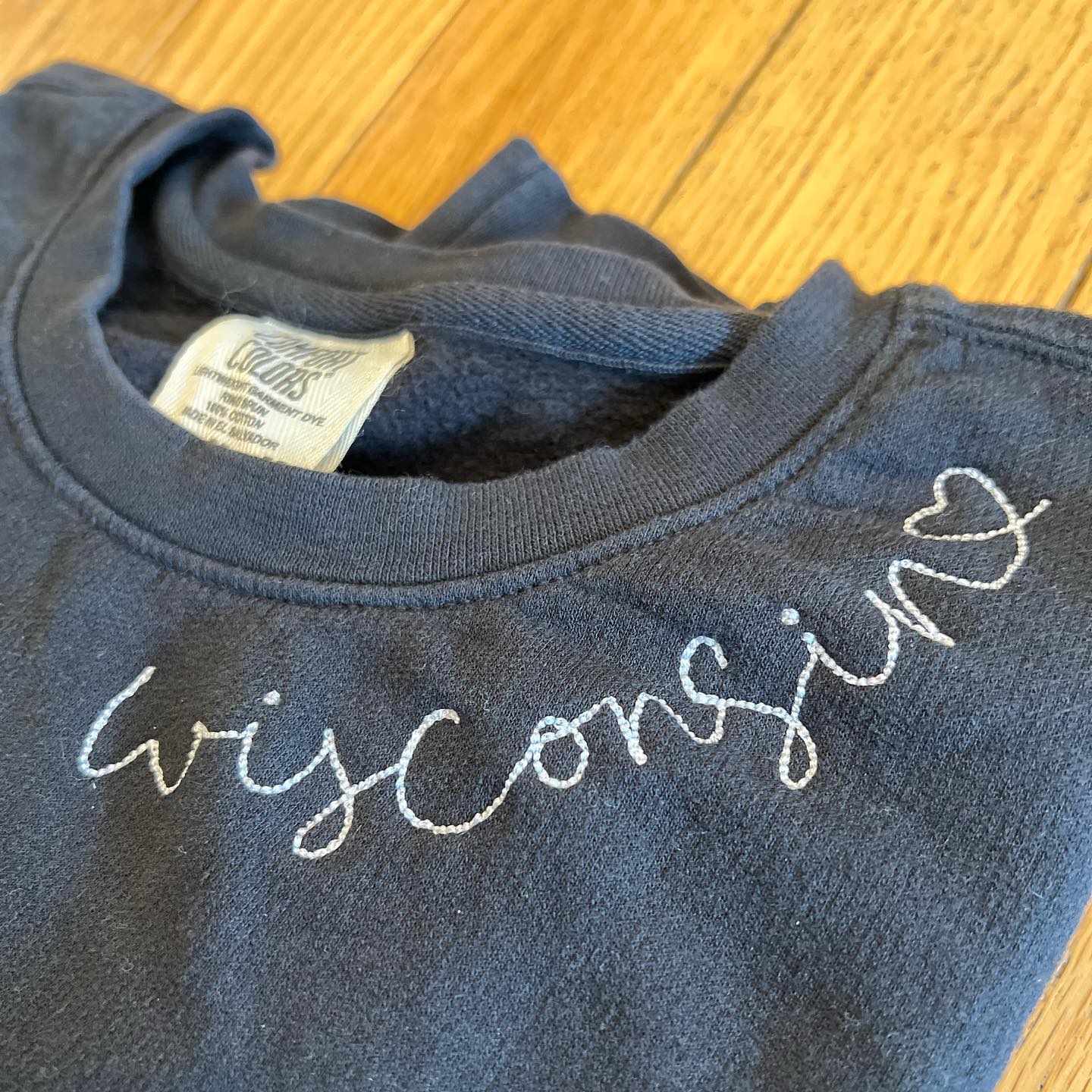 Wisconsin Script Embroidered Sweatshirt. Black.