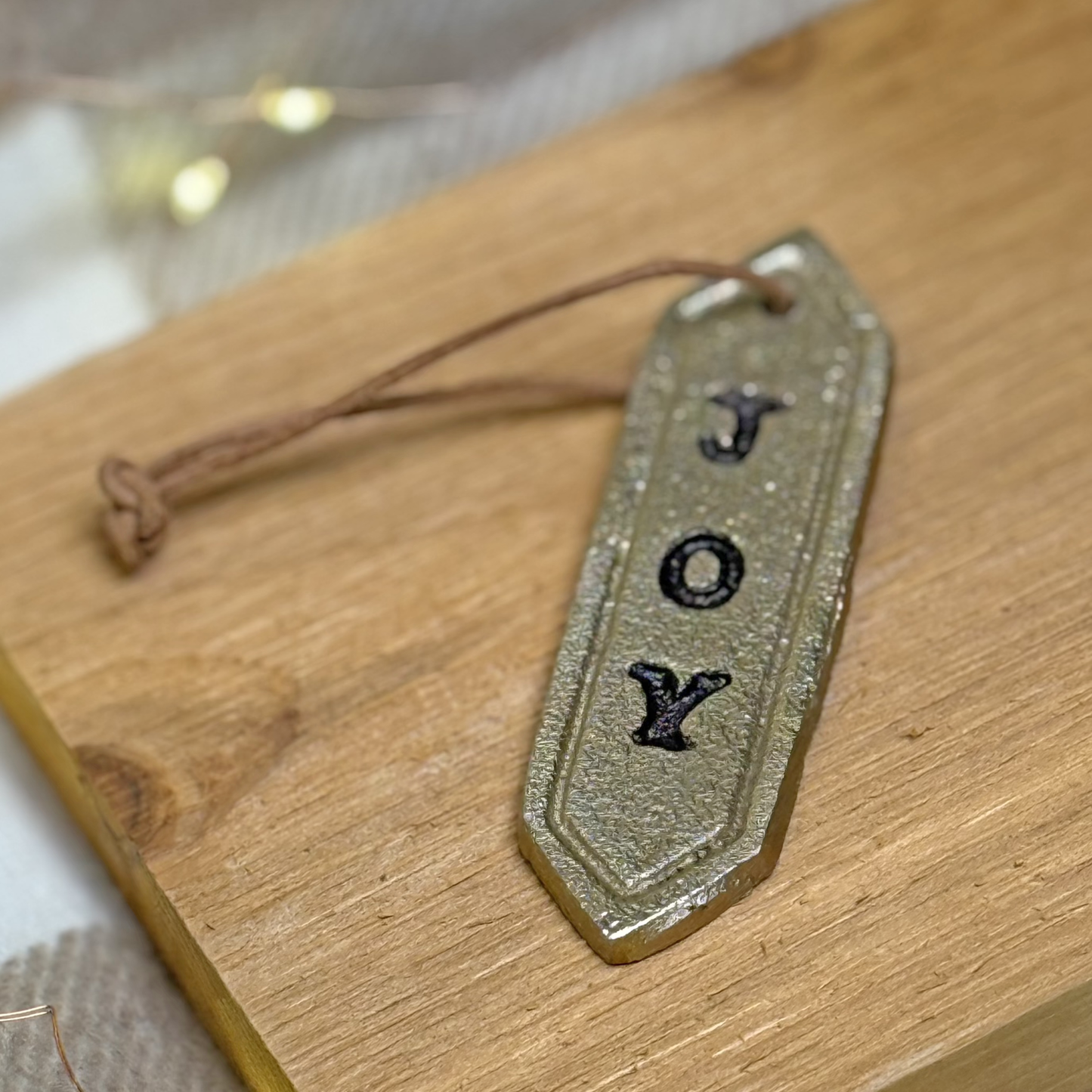 Stamped Joy Metal Ornament. Gold.